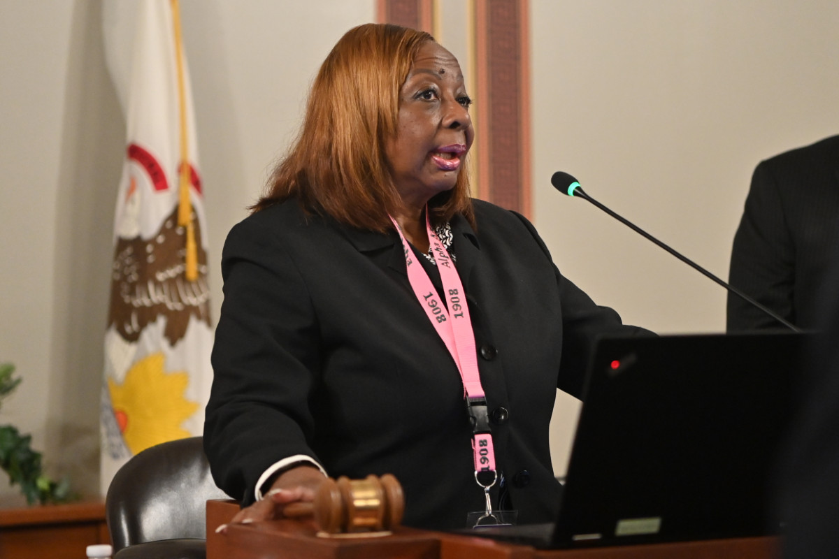 Senator Hunter speaks into a microphone while presiding over the Senate.